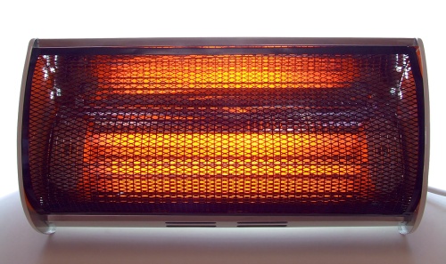 Portable electric heater with glowing heating elements, highlighting safe heating solutions for homes.
