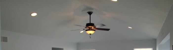 Ceiling fan installation with light fixture in a modern room, showcasing electrical services related to ceiling fan repair and maintenance.