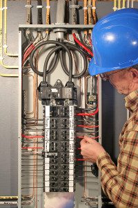 Electrician working on a service panel.